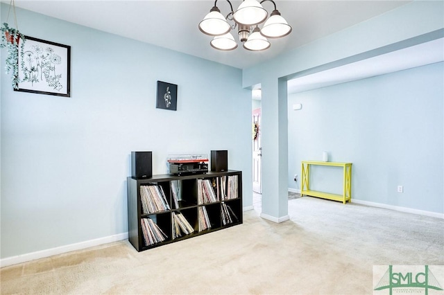 interior space featuring a chandelier, carpet flooring, and baseboards