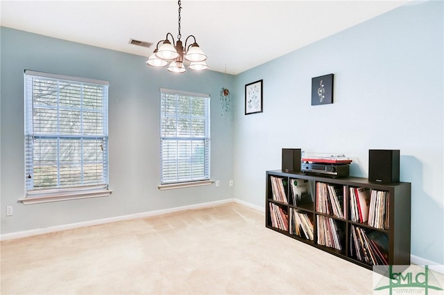 interior space with visible vents, a notable chandelier, and baseboards