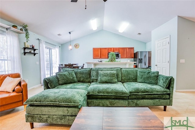 living room featuring light carpet, visible vents, a ceiling fan, vaulted ceiling, and baseboards