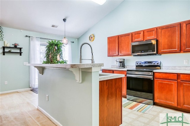 kitchen with stainless steel appliances, light countertops, vaulted ceiling, and light floors