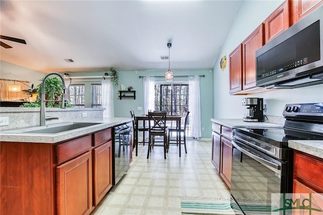 kitchen featuring range with electric cooktop, a sink, black dishwasher, light floors, and stainless steel microwave