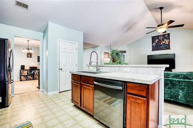 kitchen with light countertops, visible vents, freestanding refrigerator, a sink, and dishwashing machine