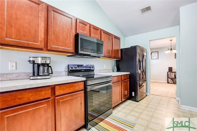 kitchen with visible vents, lofted ceiling, stainless steel appliances, light countertops, and light floors