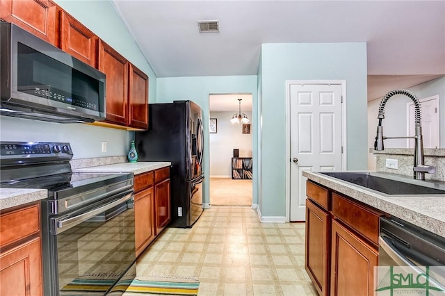 kitchen featuring visible vents, stainless steel appliances, light countertops, light floors, and a sink