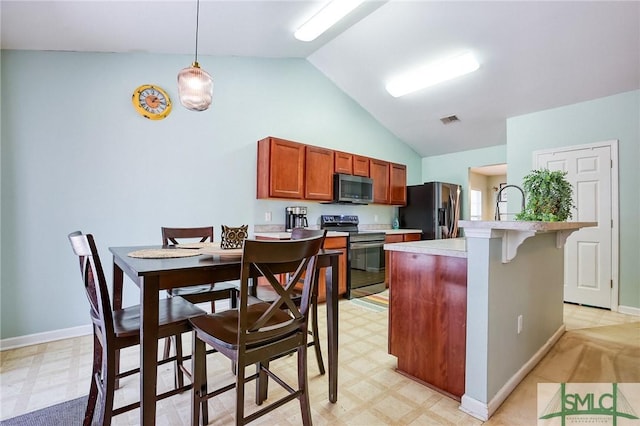 kitchen featuring light floors, light countertops, visible vents, appliances with stainless steel finishes, and vaulted ceiling