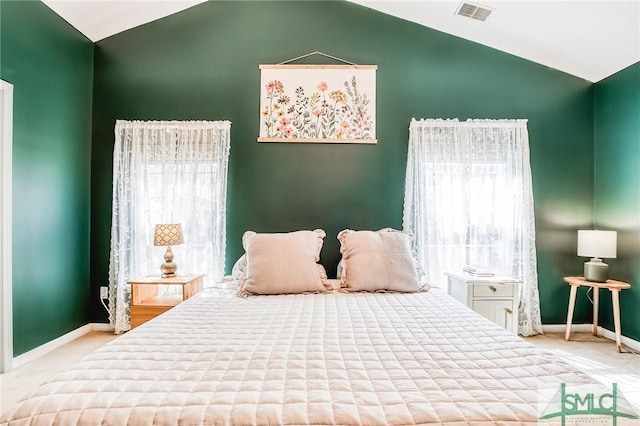 bedroom featuring lofted ceiling, carpet, visible vents, and baseboards