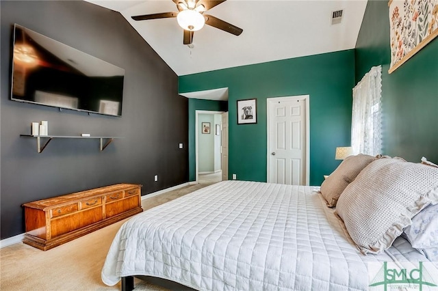 carpeted bedroom featuring baseboards, visible vents, vaulted ceiling, and a ceiling fan