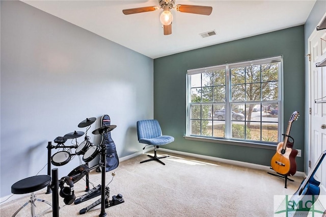 exercise room with a wealth of natural light, baseboards, visible vents, and carpet flooring