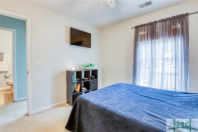 carpeted bedroom with a ceiling fan, visible vents, and baseboards