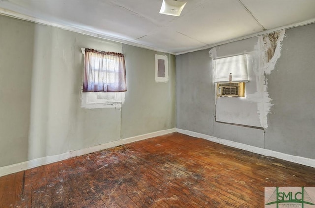 empty room with hardwood / wood-style flooring and baseboards