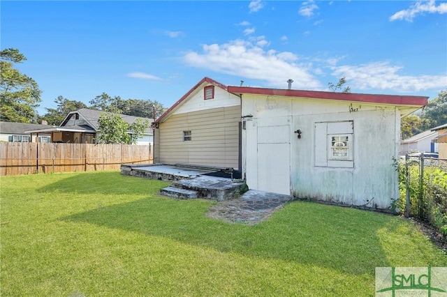 view of outbuilding featuring fence