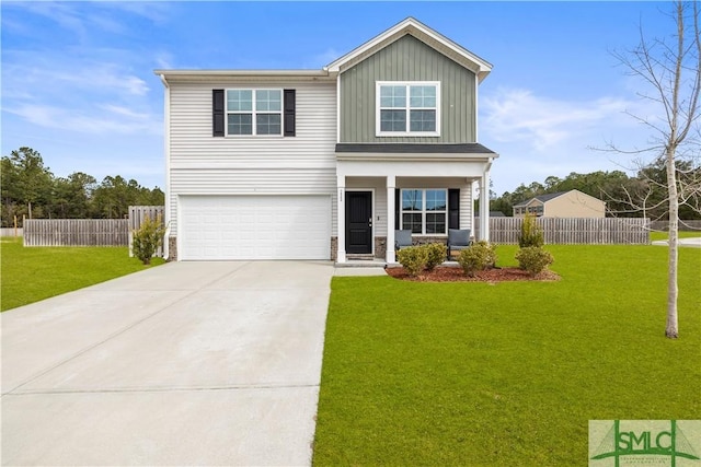 view of front of house with an attached garage, fence, board and batten siding, and a front yard