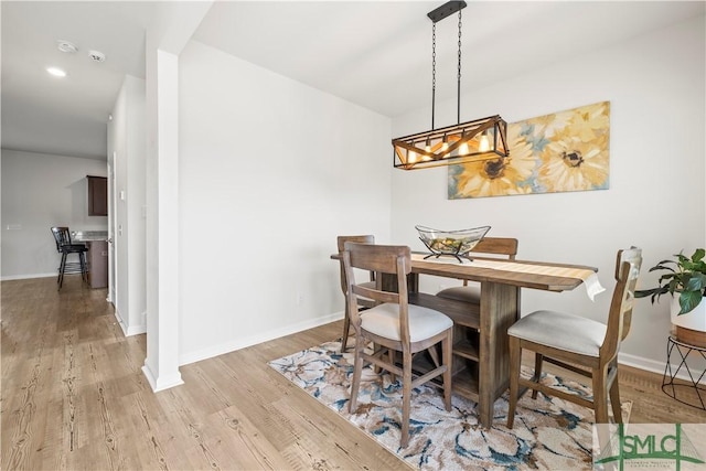 dining space with light wood finished floors, baseboards, and recessed lighting