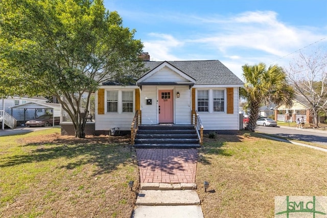 bungalow-style house featuring a front yard and roof with shingles