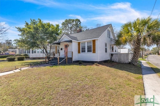 bungalow-style home with a front lawn