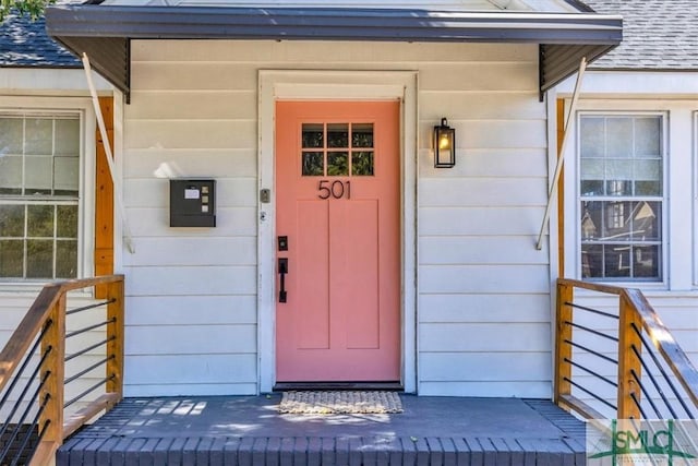 property entrance with roof with shingles