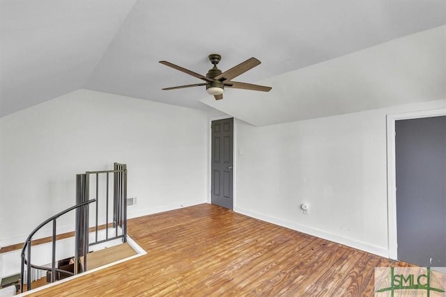 additional living space featuring vaulted ceiling, ceiling fan, wood finished floors, and baseboards