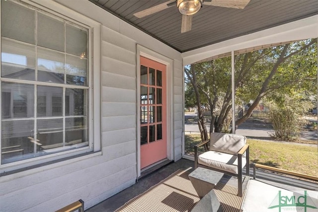 unfurnished sunroom featuring a ceiling fan