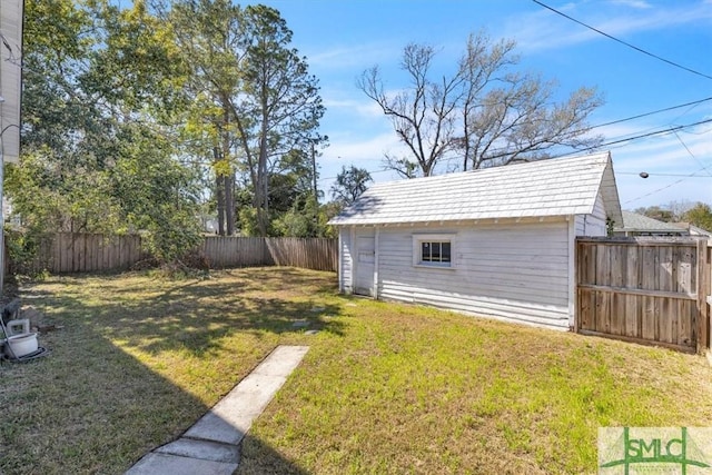 view of yard with a fenced backyard, an outdoor structure, and a shed