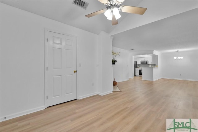 unfurnished living room with light wood-type flooring, visible vents, baseboards, and ceiling fan with notable chandelier