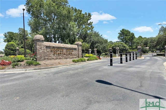 community / neighborhood sign with a gate