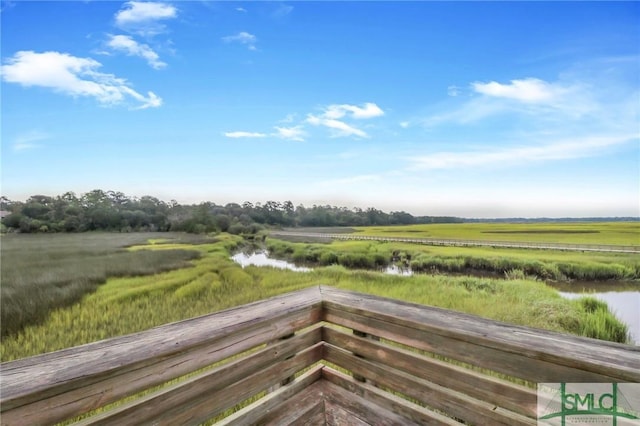 wooden terrace featuring a rural view