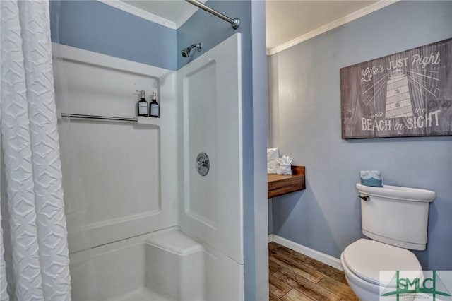 bathroom with ornamental molding, curtained shower, baseboards, and wood finished floors