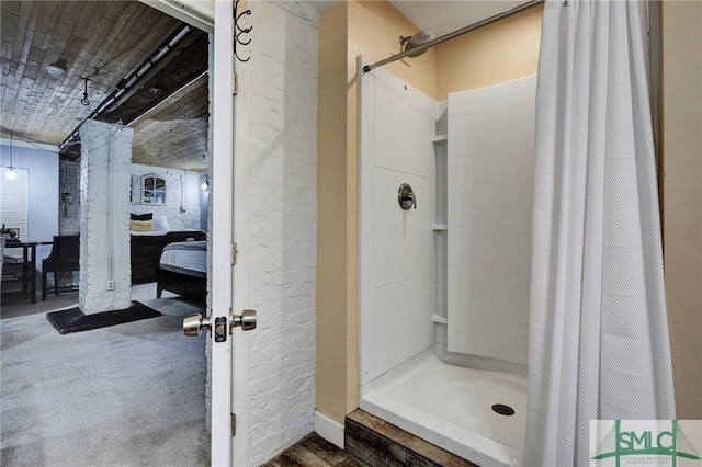 bathroom featuring a shower stall and ensuite bathroom