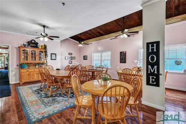 dining space with dark wood-style floors, lofted ceiling, and baseboards