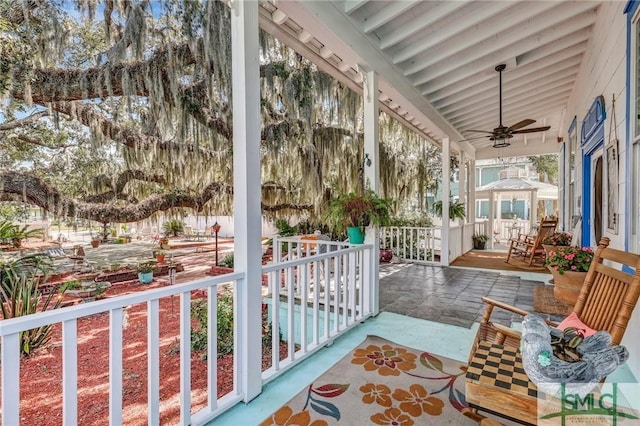 sunroom with a ceiling fan and lofted ceiling with beams