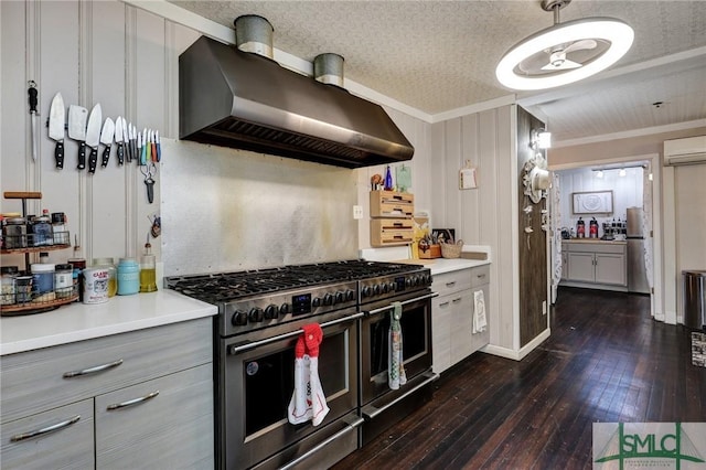 kitchen with dark wood-style flooring, gray cabinetry, a textured ceiling, double oven range, and wall chimney exhaust hood