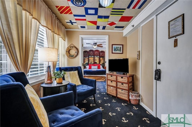 sitting room with crown molding, carpet flooring, ceiling fan, and visible vents