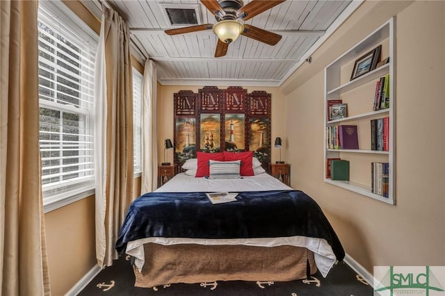 bedroom with wooden ceiling, ceiling fan, and baseboards