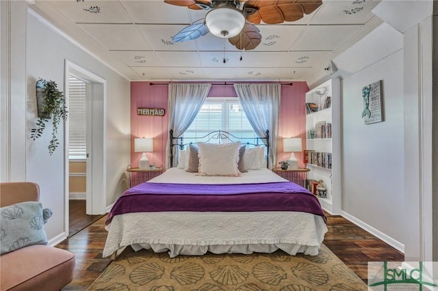 bedroom featuring wood finished floors and baseboards