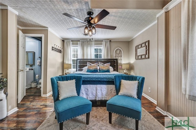 bedroom featuring ornamental molding, washer / clothes dryer, baseboards, and wood finished floors