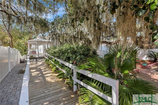 surrounding community with fence and a gazebo