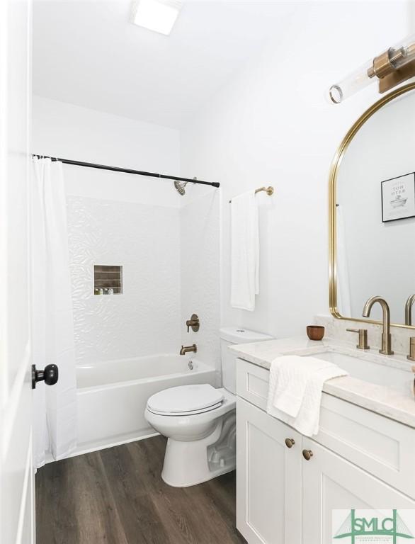 full bathroom with vanity, shower / bath combo, wood finished floors, and toilet