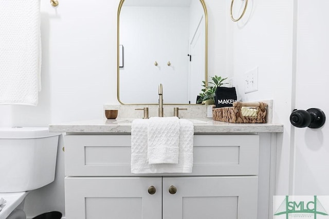 bathroom featuring toilet and vanity