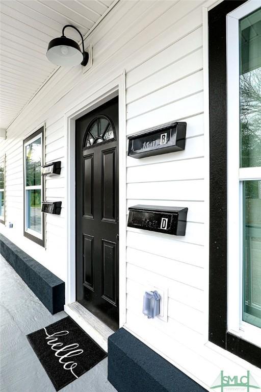 view of exterior entry with a porch