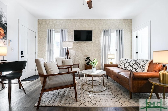 living area featuring wood finished floors and a ceiling fan