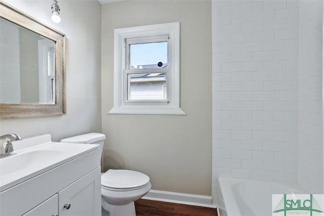 full bathroom featuring vanity, wood finished floors, toilet, and baseboards