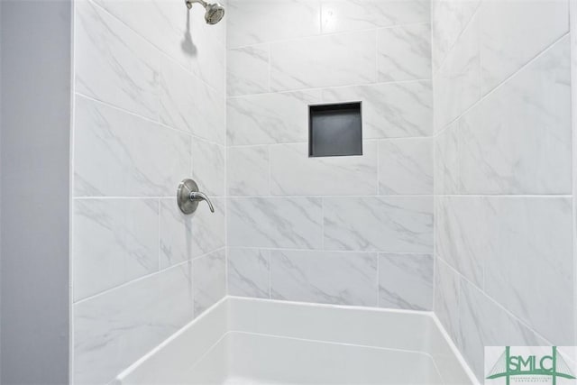 full bath with a tile shower