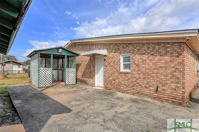 rear view of house with brick siding