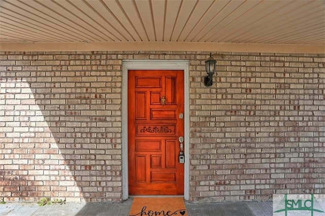 entrance to property with brick siding