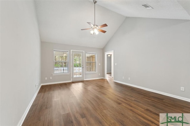 unfurnished living room featuring dark wood finished floors, visible vents, a ceiling fan, high vaulted ceiling, and baseboards