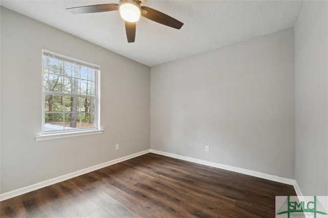 unfurnished room with ceiling fan, baseboards, dark wood finished floors, and a textured ceiling