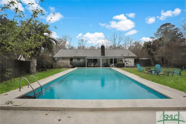 pool featuring a yard, a patio, and a fenced backyard