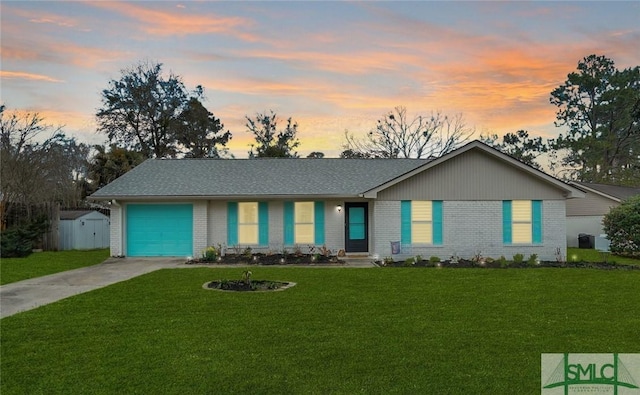 ranch-style house featuring driveway, brick siding, an attached garage, and a front yard