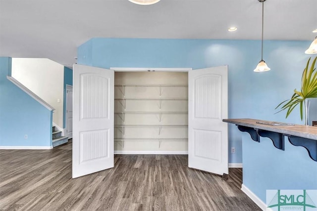 interior space featuring stairway, baseboards, and wood finished floors