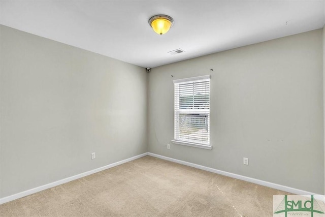 carpeted spare room featuring baseboards and visible vents